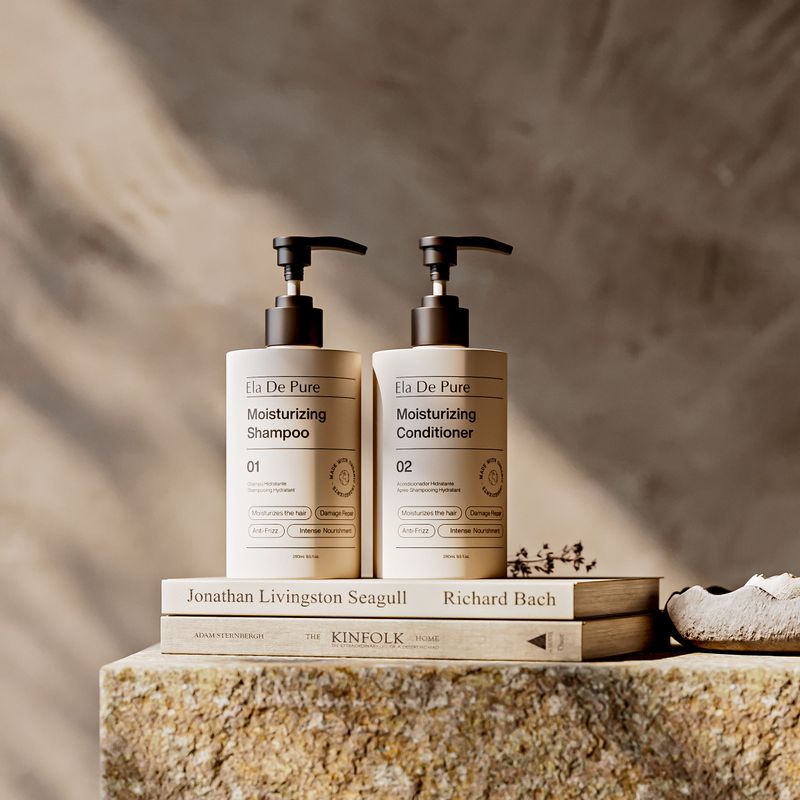 Gentle Argan Shampoo bottle by a bath