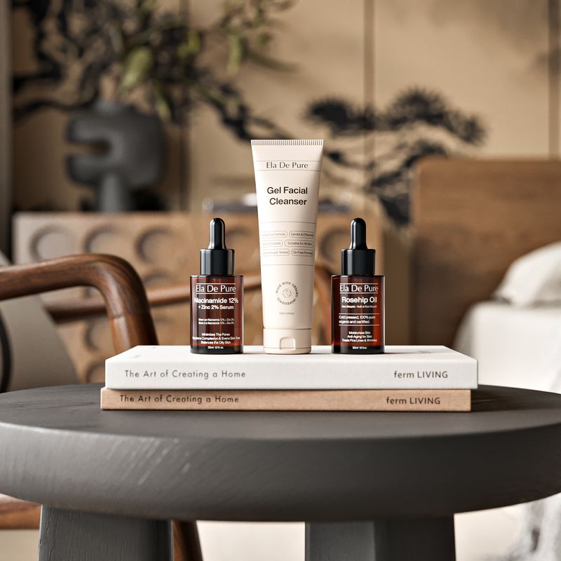Rose Argan Cleanser bottle beside rose petals